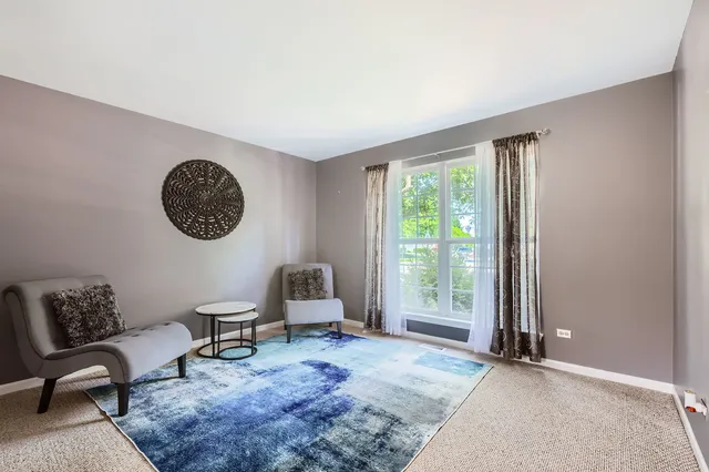 a view of a livingroom with furniture and a window