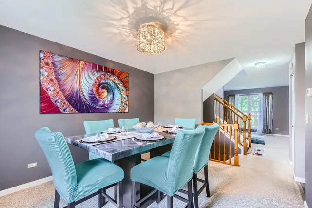 a dining room with furniture and a chandelier