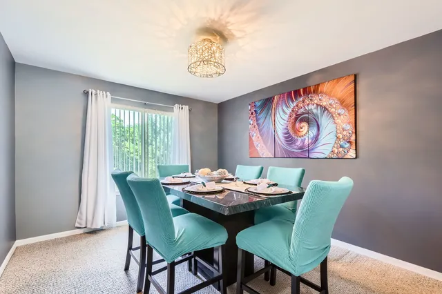 a dining room with furniture and window