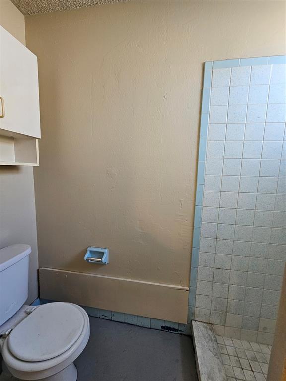 6324 Lomand Avenue New Port Richey, FL 34653 - Photo 13 of 16 a white toilet and shower sitting next to a bathroom sink