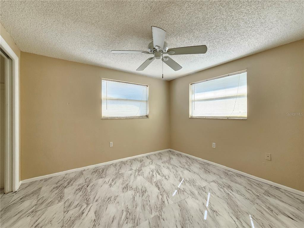 6324 Lomand Avenue New Port Richey, FL 34653 - Photo 7 of 16 wooden floor in an empty room with a window