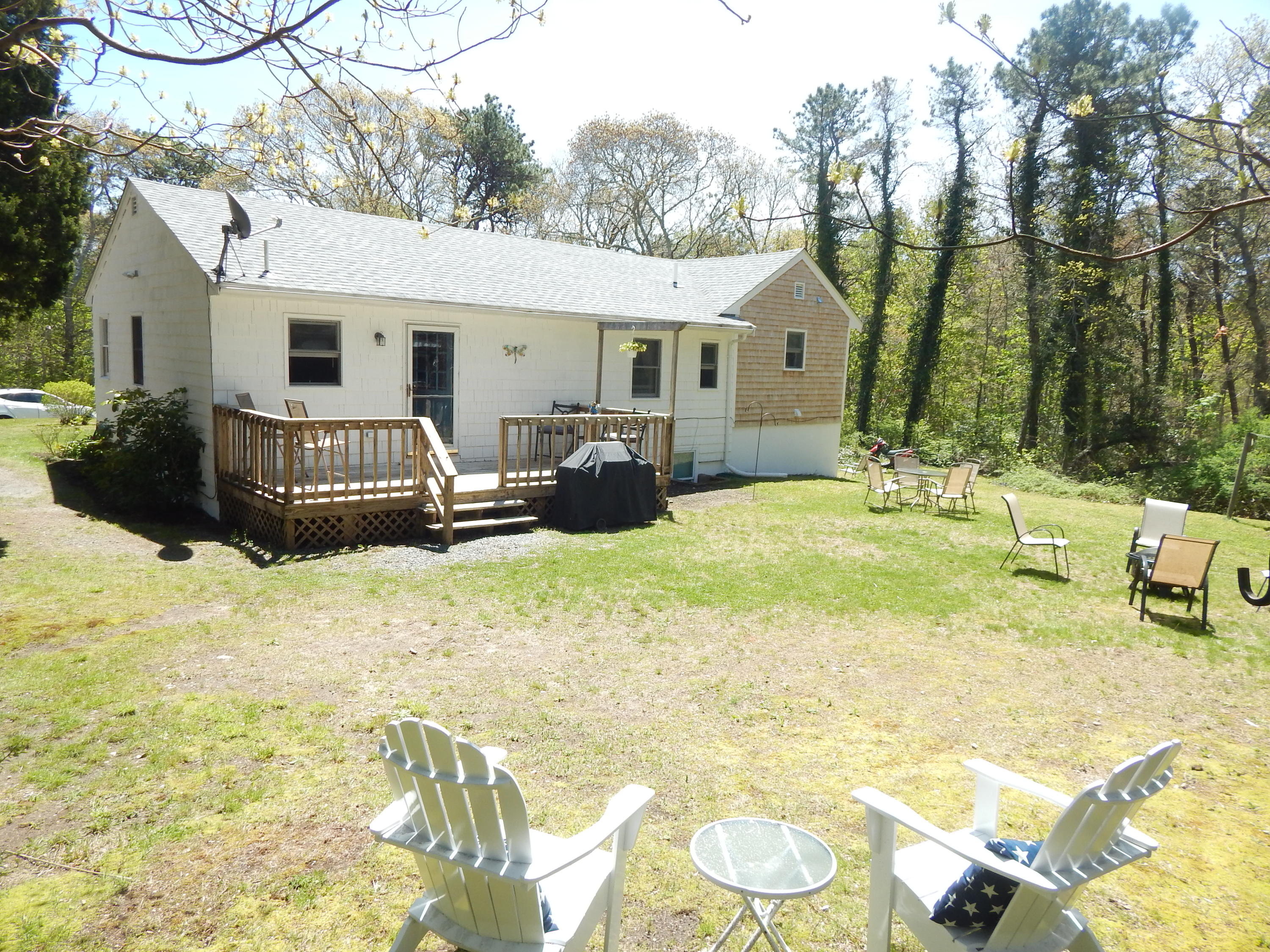 a view of a house with a yard and sitting area