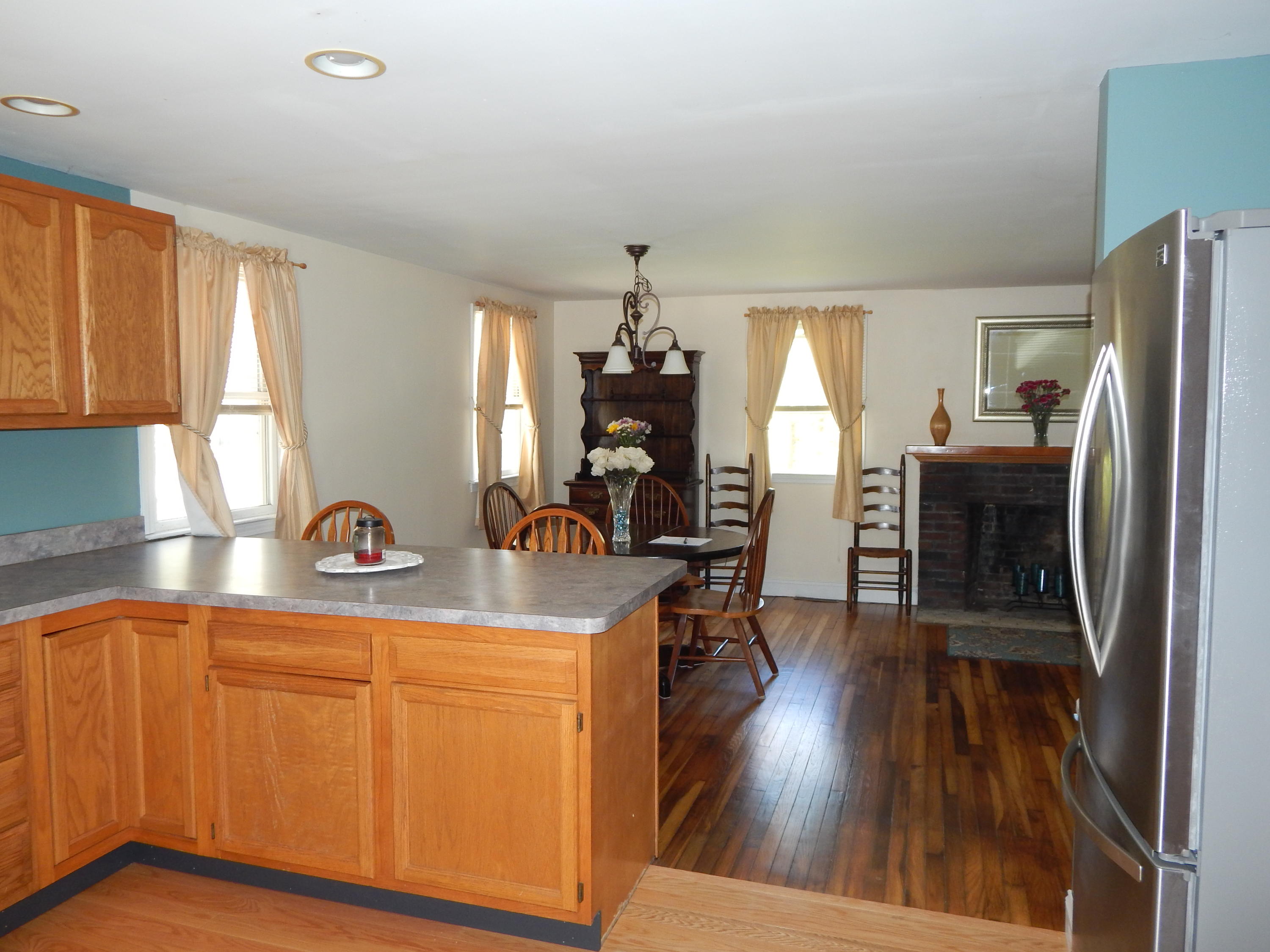 267 Lincoln Road Hyannis, MA 02601 - Photo 11 of 30 a kitchen with sink refrigerator dining table and chairs