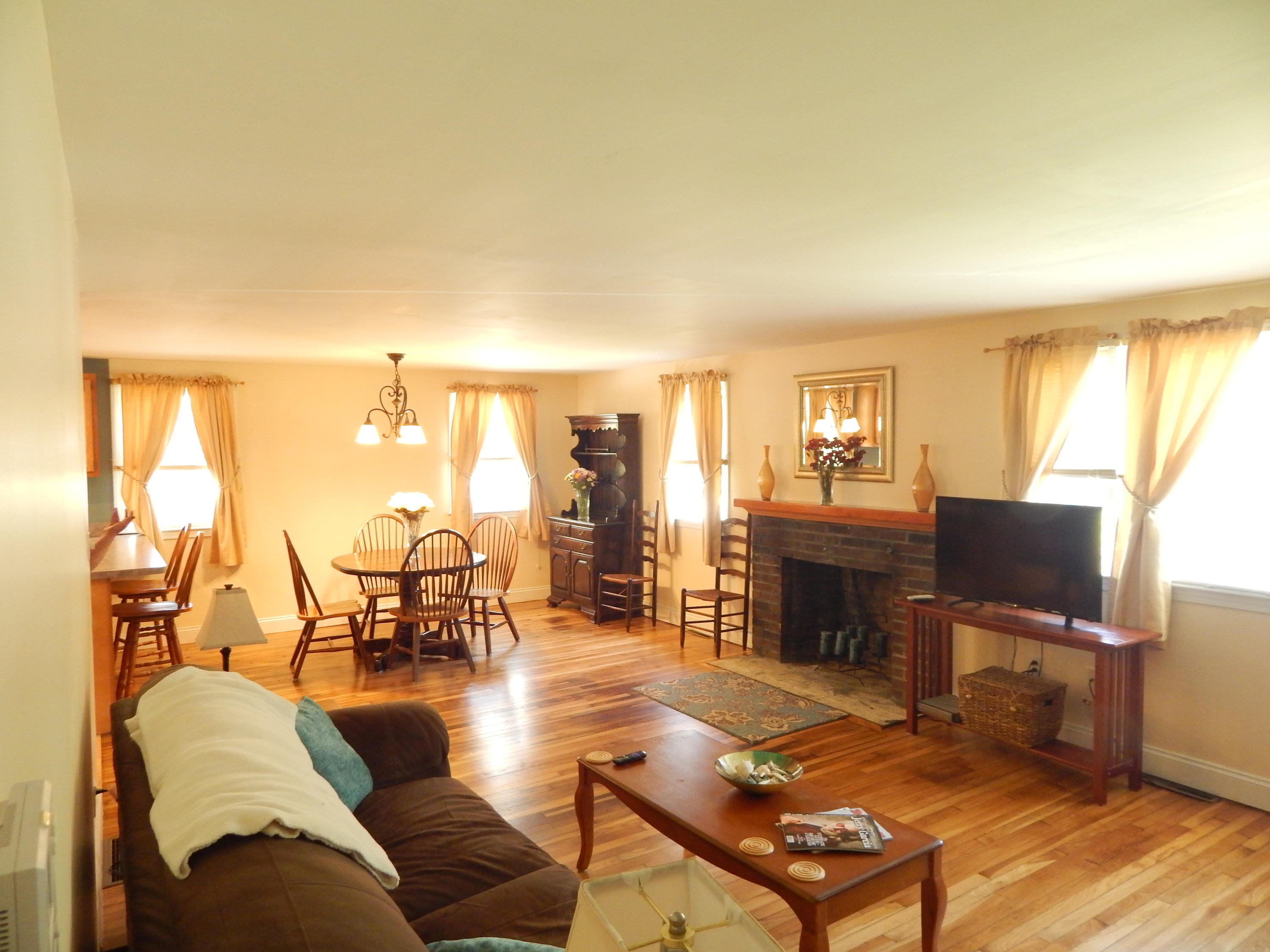 267 Lincoln Road Hyannis, MA 02601 - Photo 15 of 30 a living room with furniture a dining table and chairs with wooden floor