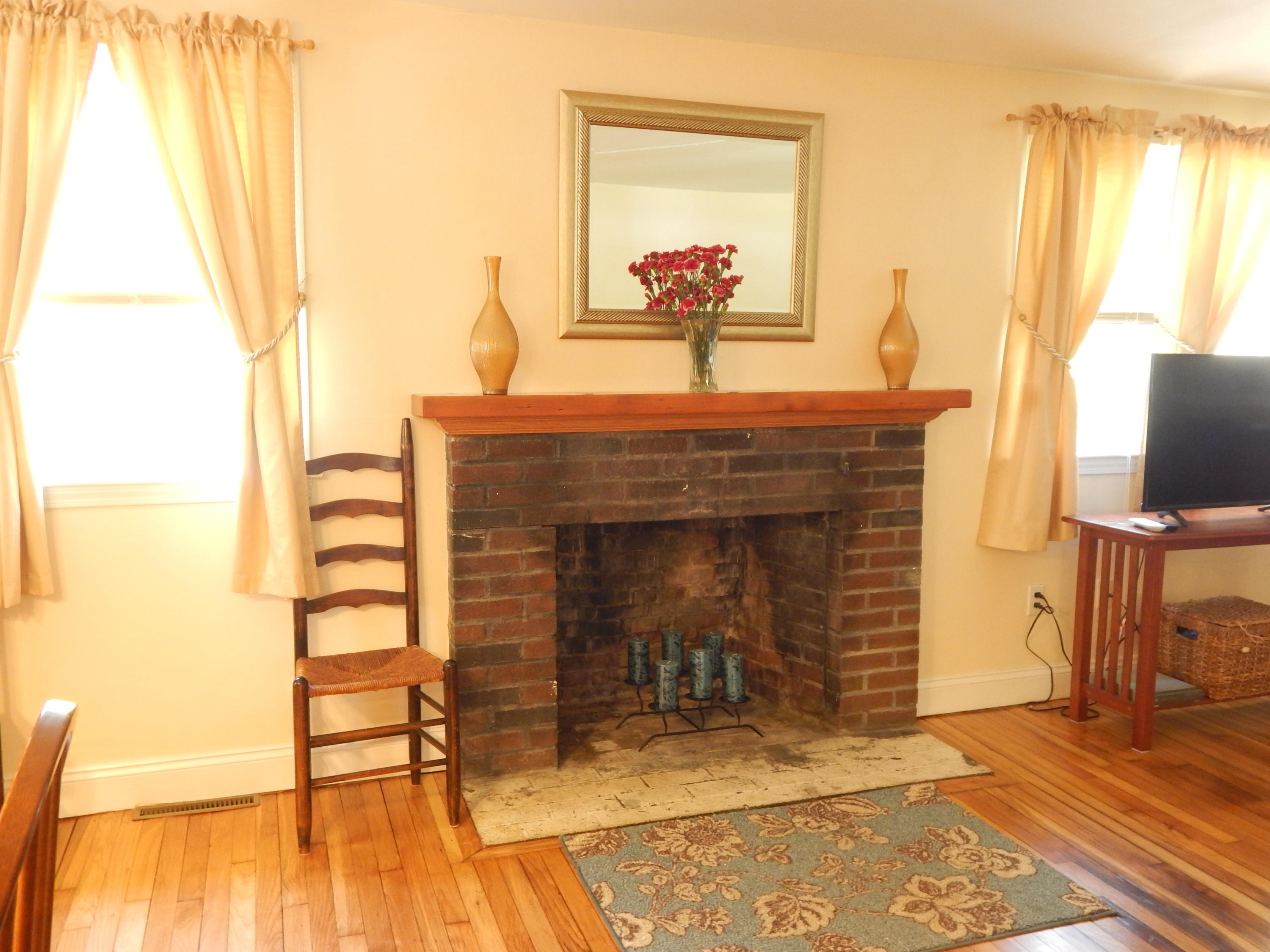 267 Lincoln Road Hyannis, MA 02601 - Photo 16 of 30 a living room with furniture and a fireplace