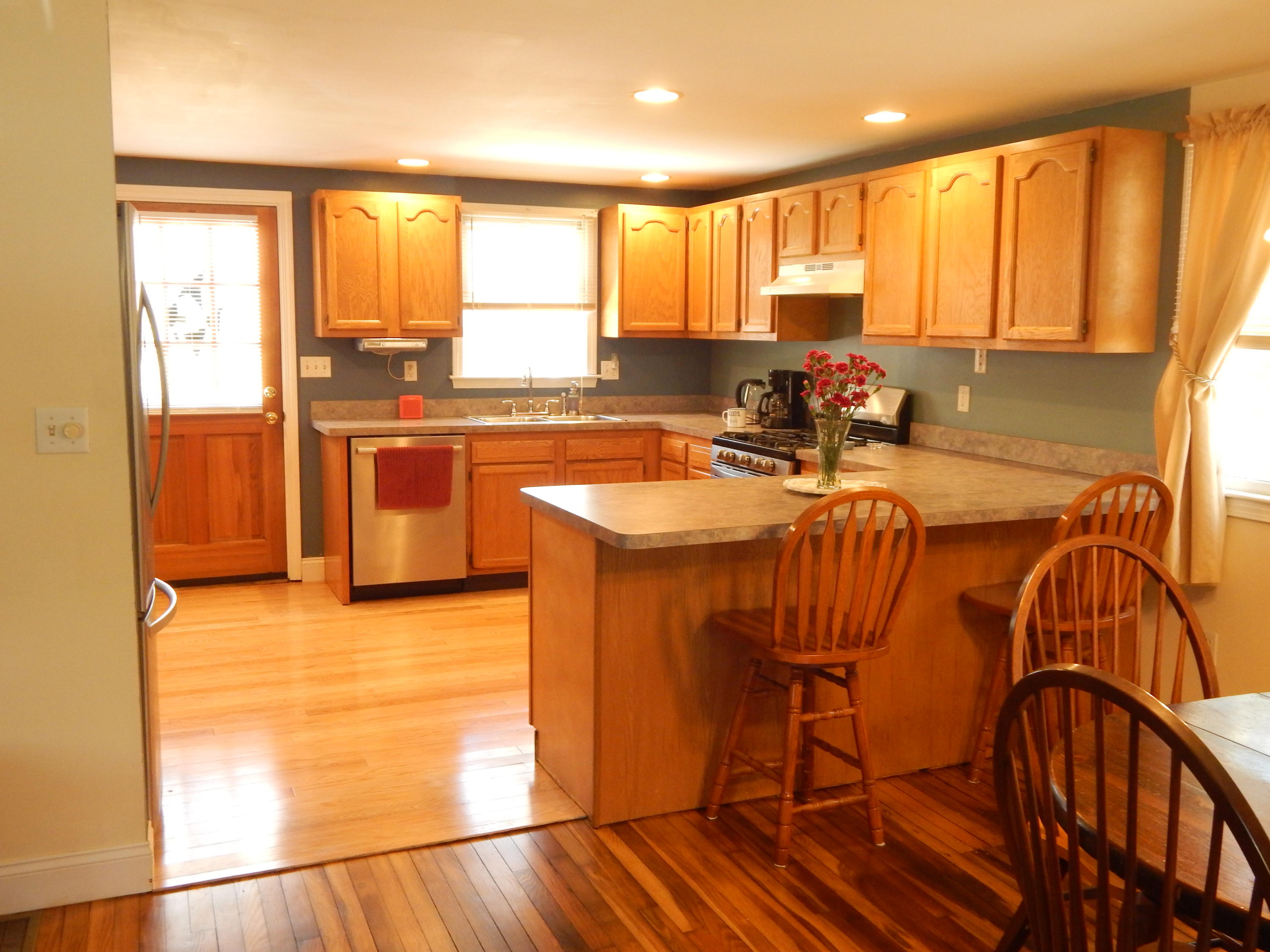 267 Lincoln Road Hyannis, MA 02601 - Photo 8 of 30 a kitchen with stainless steel appliances granite countertop a stove a sink and a refrigerator