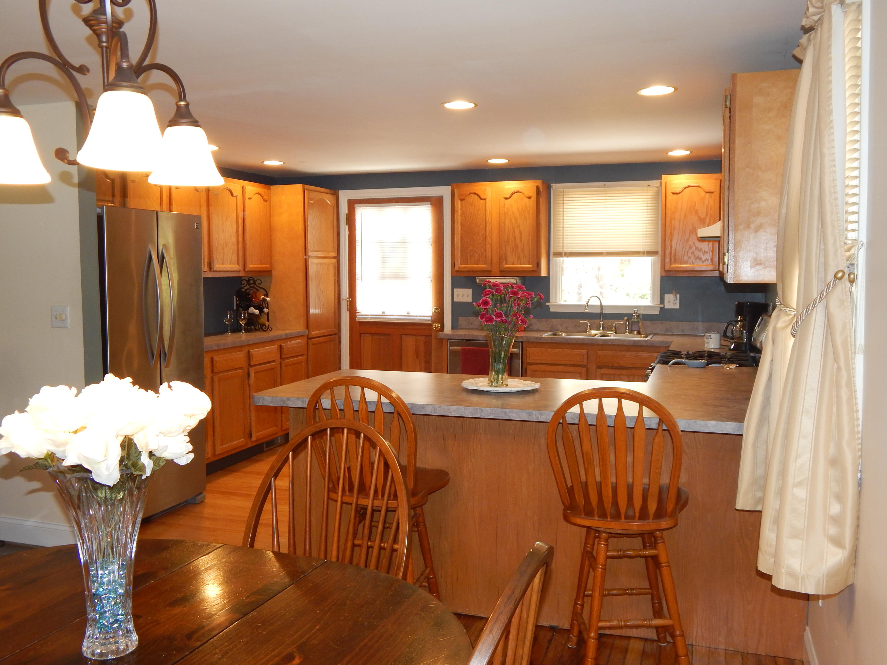 267 Lincoln Road Hyannis, MA 02601 - Photo 9 of 30 a view of a dining room and livingroom with furniture wooden floor a chandelier
