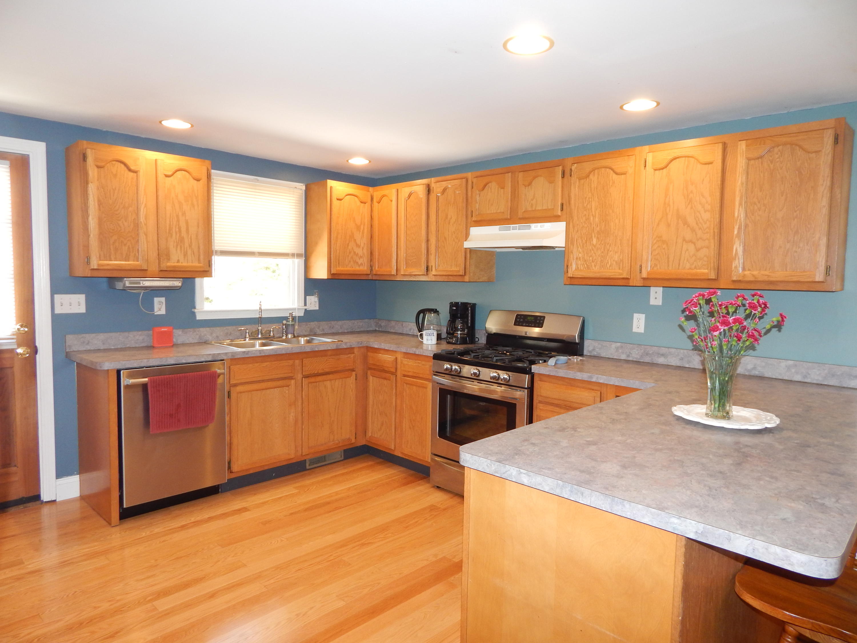 267 Lincoln Road Hyannis, MA 02601 - Photo 10 of 30 a kitchen with granite countertop wooden floors stainless steel appliances a sink and a window