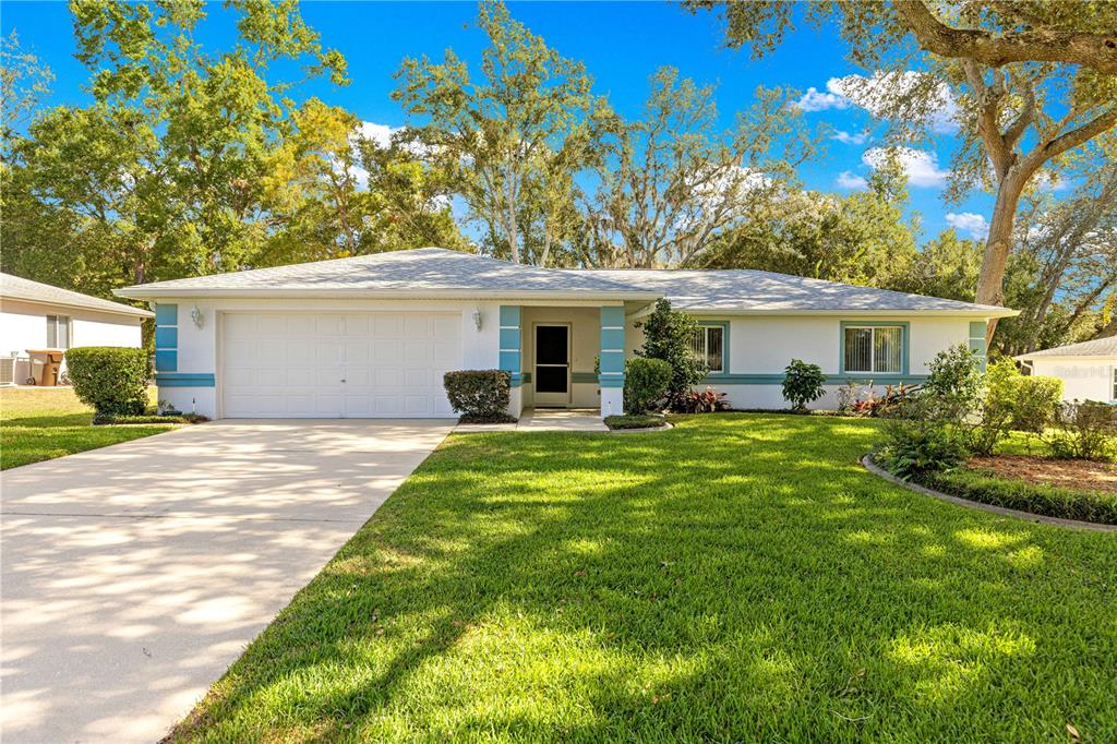 10501 Southwest 60th Terrace Ocala, FL 34476 - Photo 1 of 1 a front view of a house with a garden and plants
