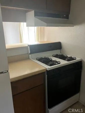 a kitchen with a stove and a refrigerator