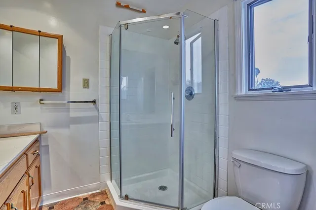 a bathroom with a shower a toilet and sink