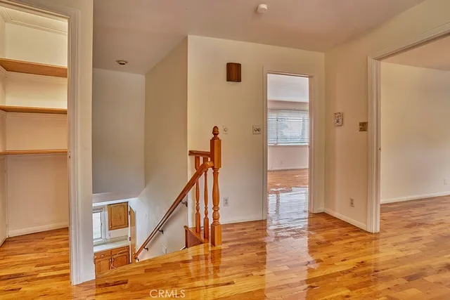 a view of a hallway with wooden floor and entryway
