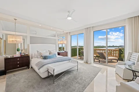 a bedroom with a large bed and a large window