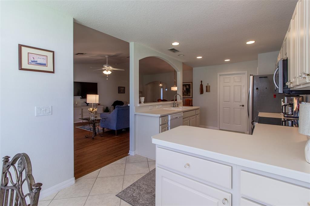 15691 Southwest 11th Court Road Ocala, FL 34473 - Photo 15 of 37 a kitchen with a refrigerator and a sink