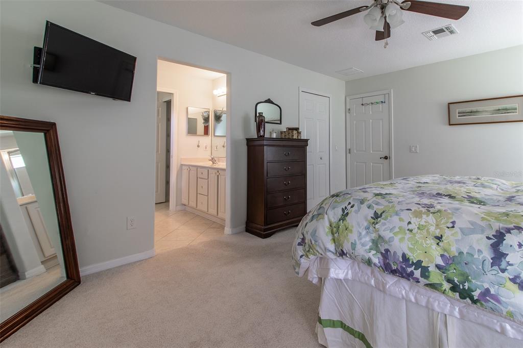 15691 Southwest 11th Court Road Ocala, FL 34473 - Photo 17 of 37 a bedroom with a bed and a television