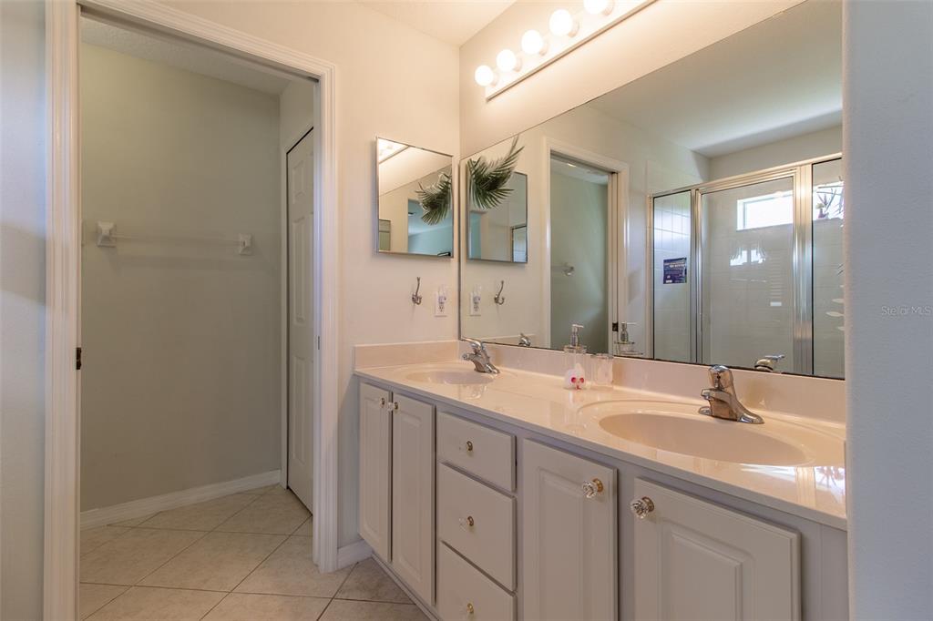 15691 Southwest 11th Court Road Ocala, FL 34473 - Photo 19 of 37 a bathroom with a granite countertop sink and a mirror