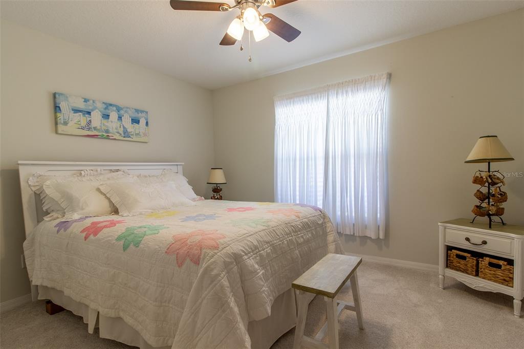 15691 Southwest 11th Court Road Ocala, FL 34473 - Photo 23 of 37 a bedroom with a bed and a chandelier