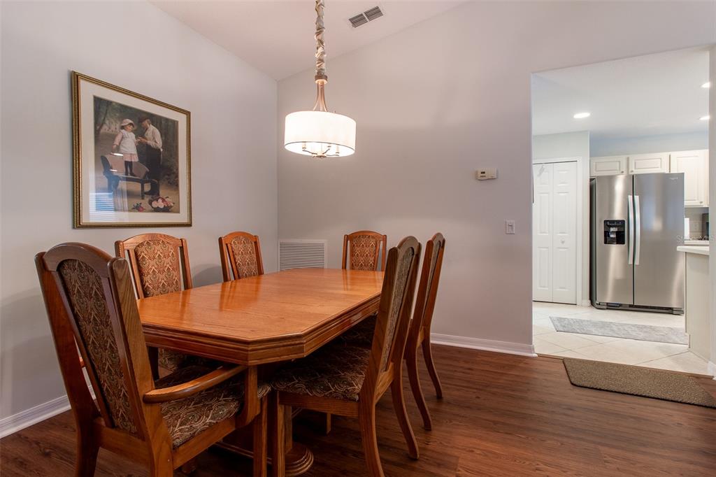 15691 Southwest 11th Court Road Ocala, FL 34473 - Photo 7 of 37 a view of a dining room with furniture wooden floor and a chandelier