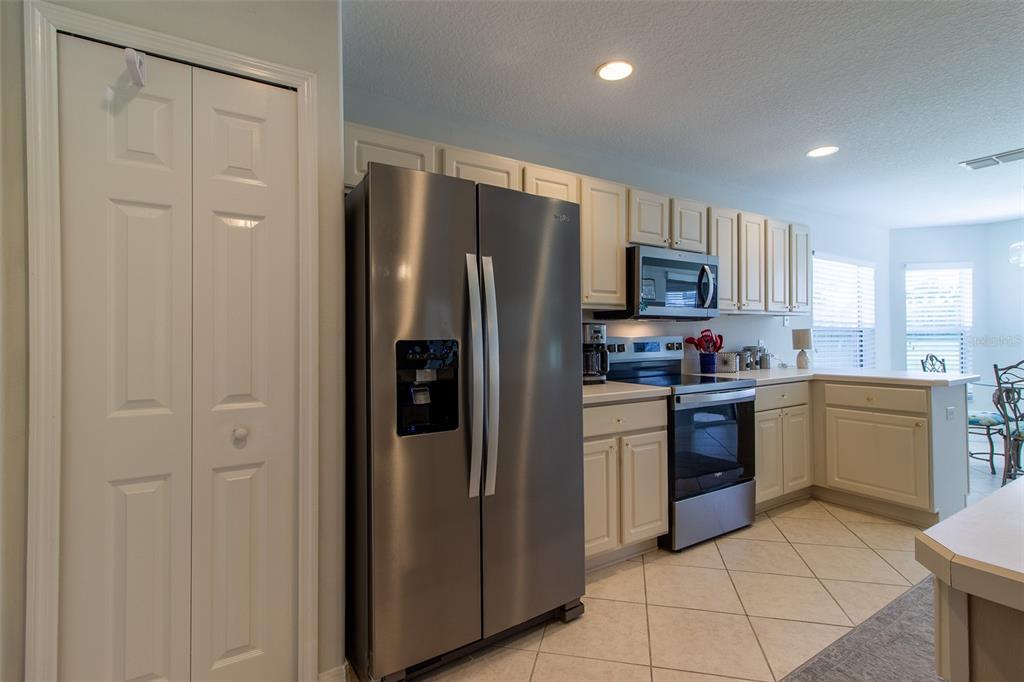 15691 Southwest 11th Court Road Ocala, FL 34473 - Photo 9 of 37 a kitchen with a refrigerator sink and microwave