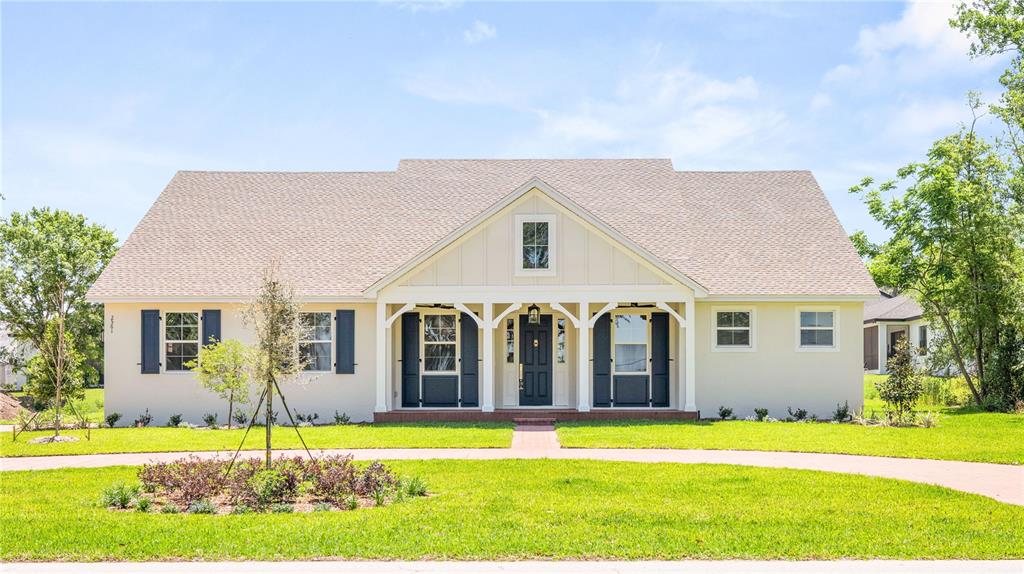 a big house with a big yard and large trees