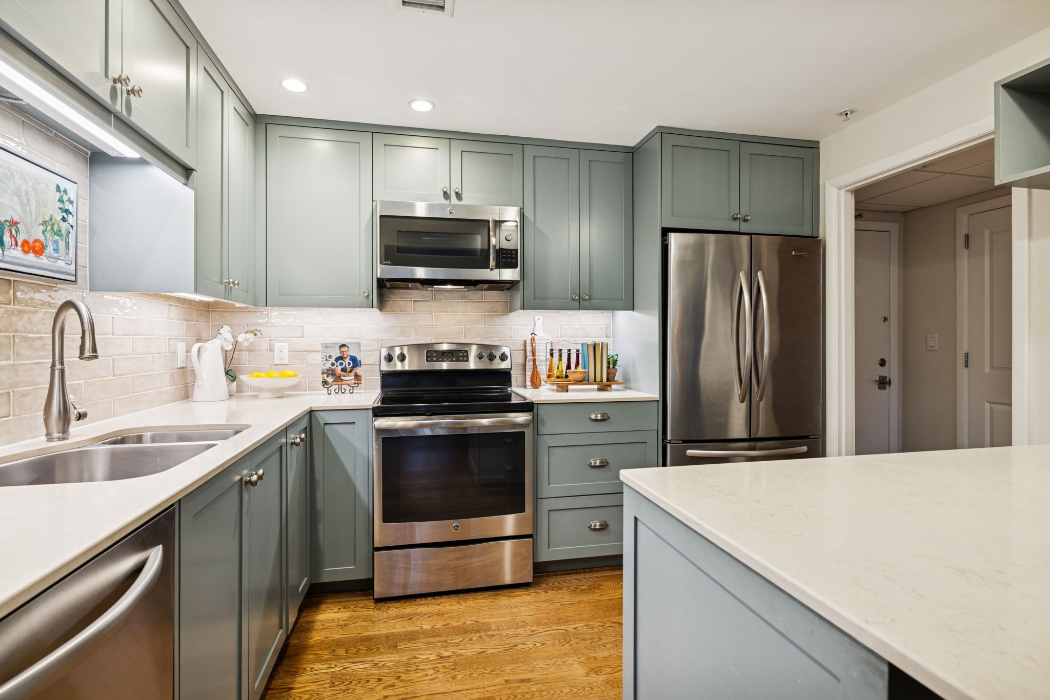 4215 Harding Pike, Unit 204 Nashville, TN 37205 - Photo 18 of 40 a kitchen with stainless steel appliances a stove refrigerator sink and microwave