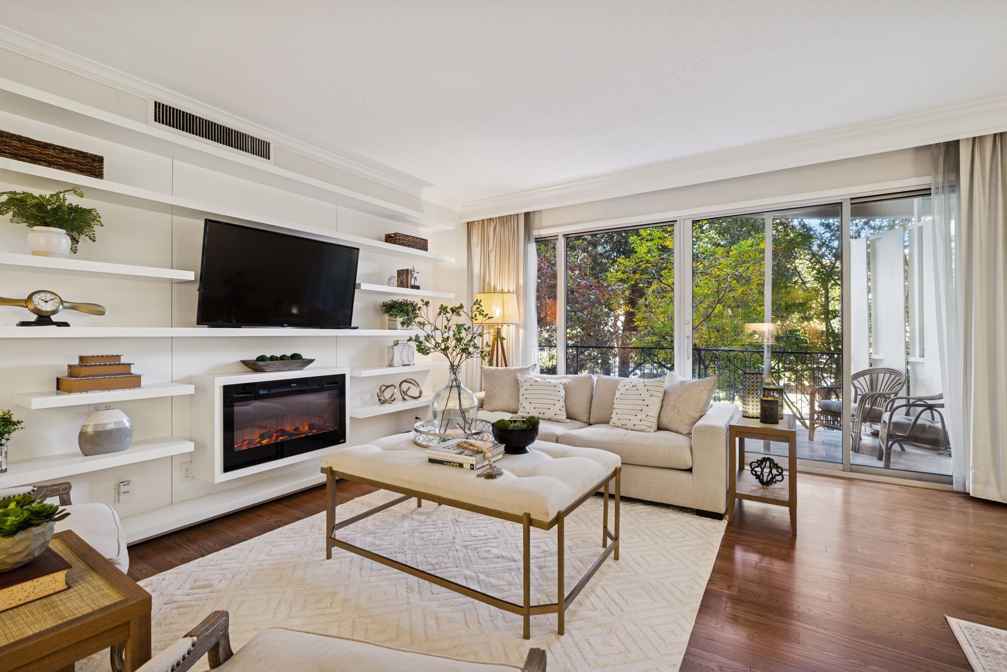 4215 Harding Pike, Unit 204 Nashville, TN 37205 - Photo 8 of 40 a living room with furniture a flat screen tv and a fireplace