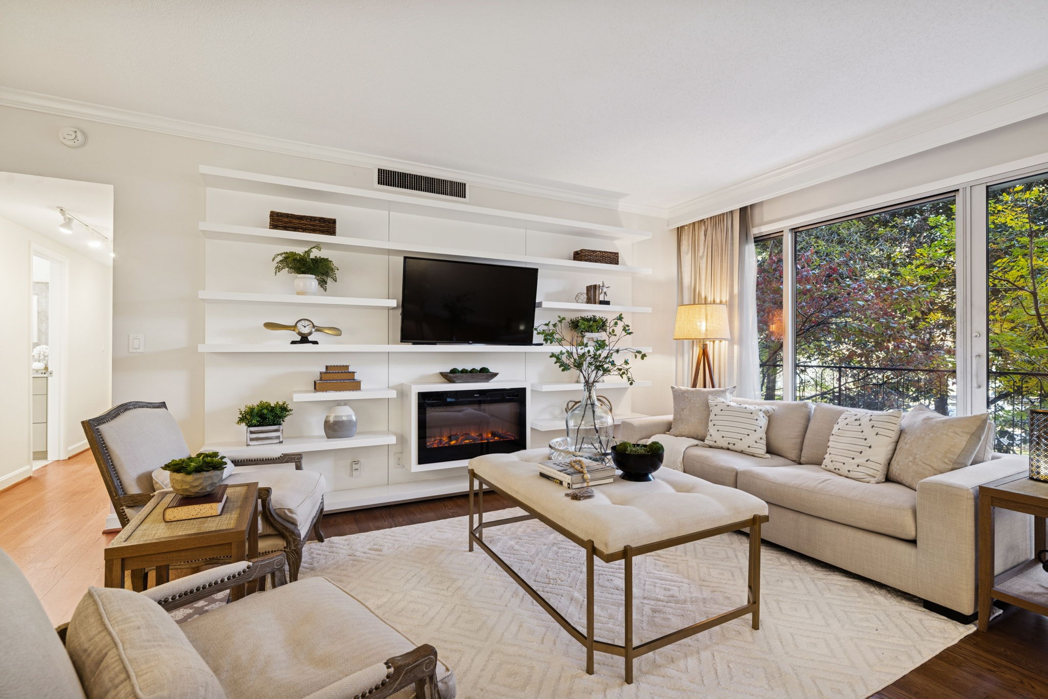 4215 Harding Pike, Unit 204 Nashville, TN 37205 - Photo 9 of 40 a living room with furniture a flat screen tv and a fireplace