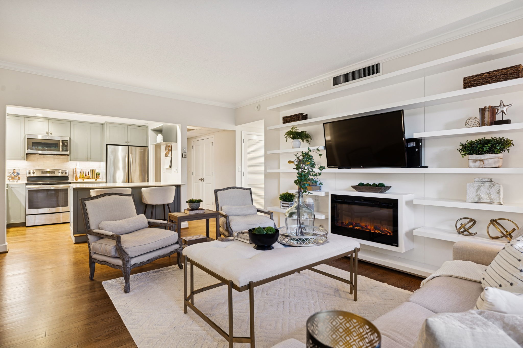 4215 Harding Pike, Unit 204 Nashville, TN 37205 - Photo 10 of 40 a living room with furniture a flat screen tv and a fireplace