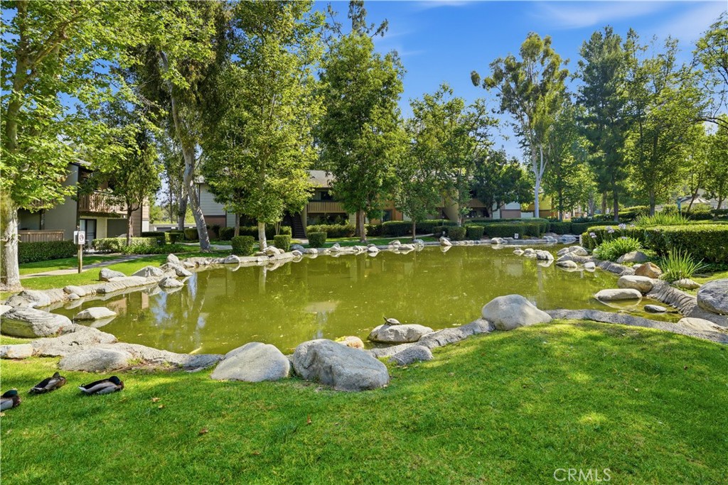 20702 El Toro Road, Unit 231 Lake Forest, CA 92630 - Photo 33 of 36 a view of a lake with houses
