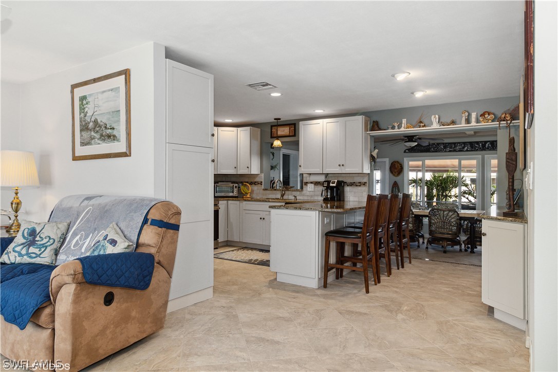 3554 Ruby Avenue St. James City, FL 33956 - Photo 16 of 43 a living room with furniture a dining table and kitchen view