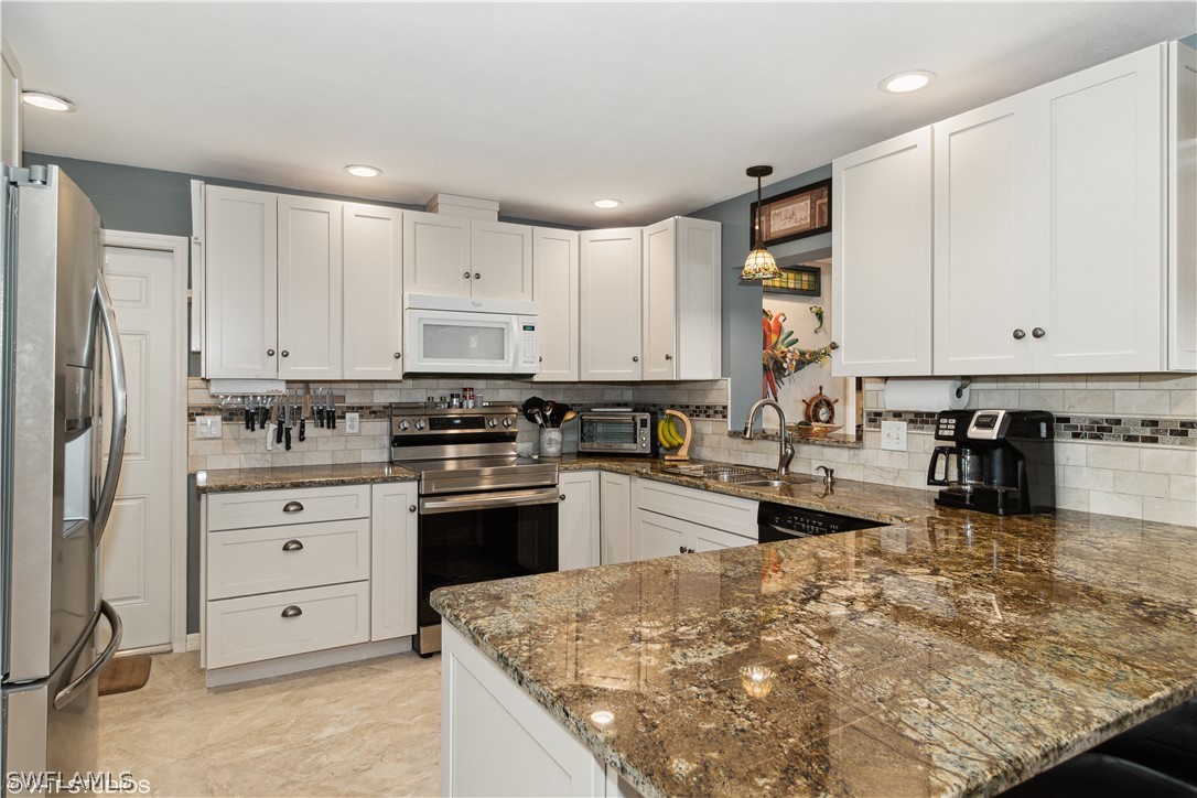 3554 Ruby Avenue St. James City, FL 33956 - Photo 18 of 43 a large kitchen with cabinets