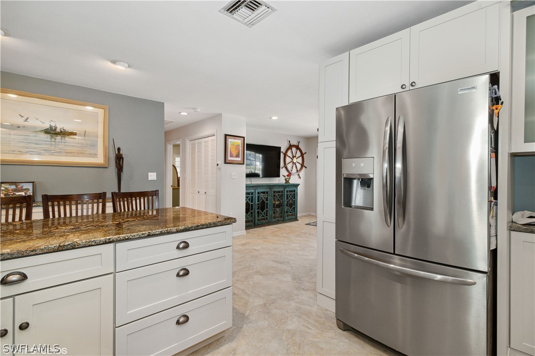 3554 Ruby Avenue St. James City, FL 33956 - Photo 20 of 43 a kitchen with stainless steel appliances granite countertop a refrigerator and a sink