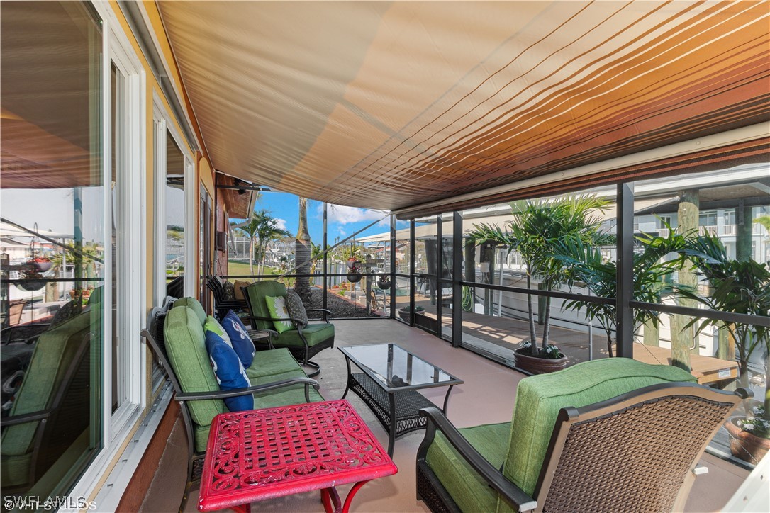 3554 Ruby Avenue St. James City, FL 33956 - Photo 27 of 43 a balcony with furniture and a potted plant