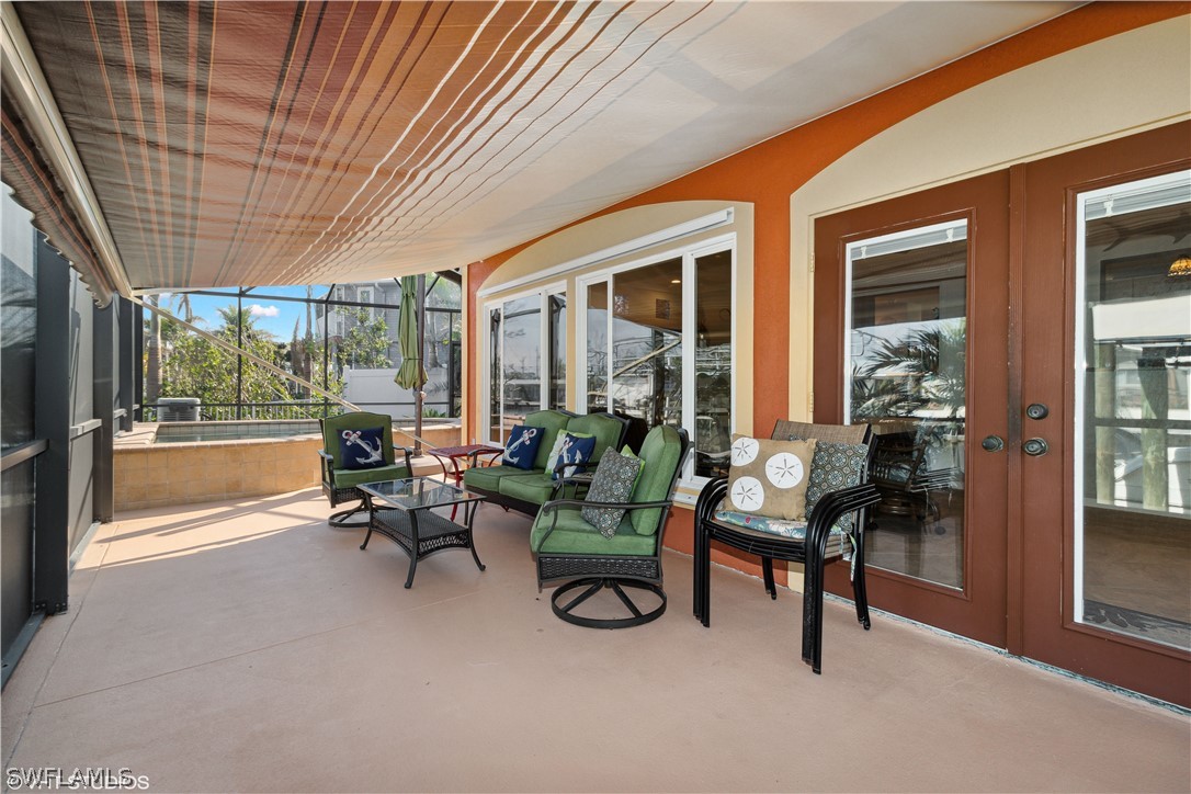 3554 Ruby Avenue St. James City, FL 33956 - Photo 28 of 43 a living room with furniture and a floor to ceiling window