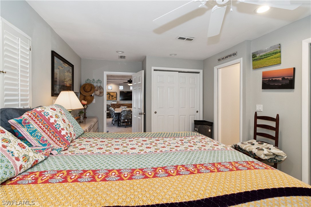 3554 Ruby Avenue St. James City, FL 33956 - Photo 30 of 43 a bedroom with a bed and wooden floor