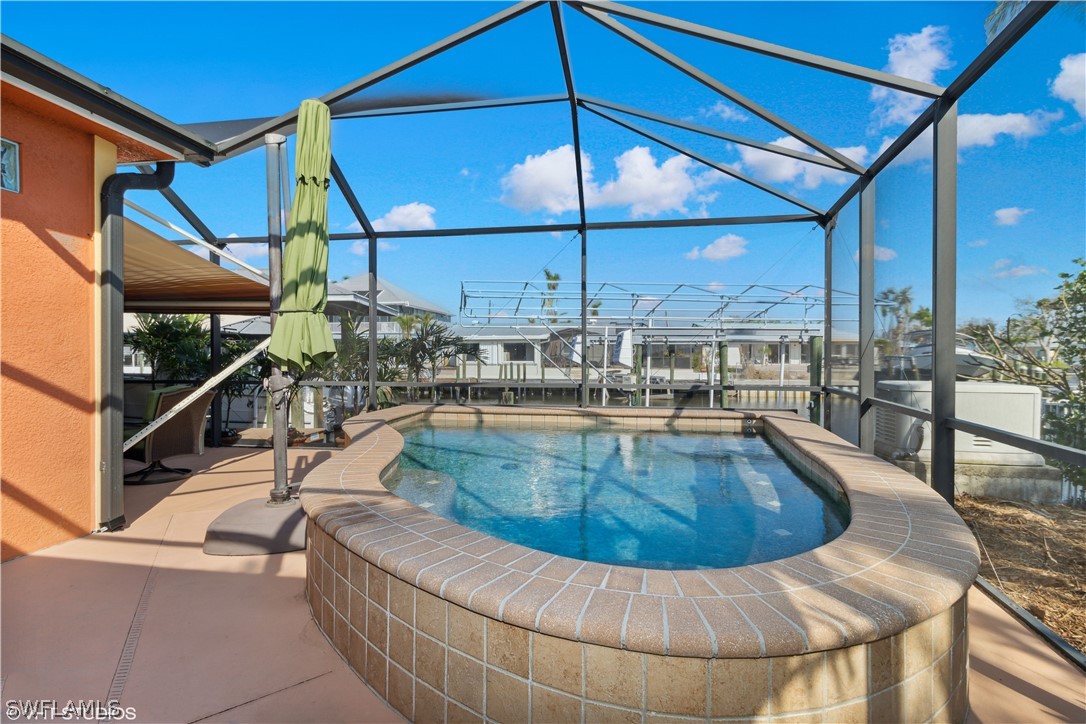 3554 Ruby Avenue St. James City, FL 33956 - Photo 3 of 43 a view of a swimming pool with a patio