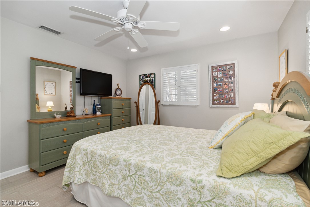 3554 Ruby Avenue St. James City, FL 33956 - Photo 33 of 43 a bedroom with a large bed and a flat screen tv