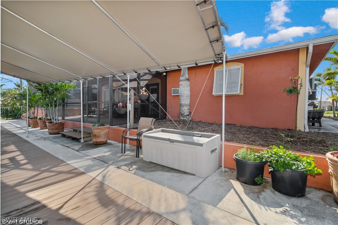 3554 Ruby Avenue St. James City, FL 33956 - Photo 39 of 43 a view of a patio with table and chairs potted plants