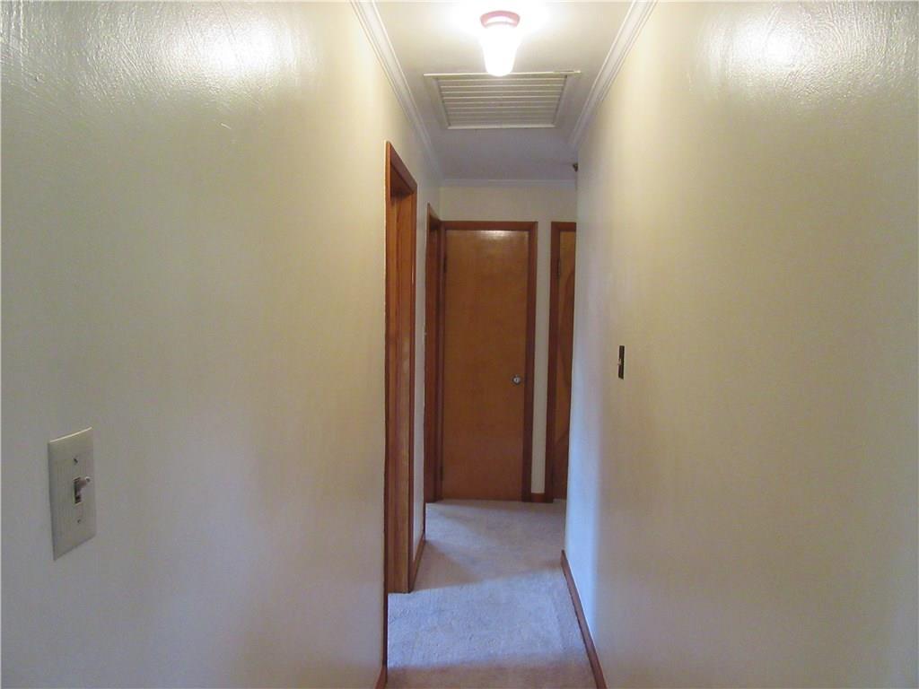 511 Coal Valley Road Jefferson Hills, PA 15025 - Photo 11 of 25 Hallway wraps from the entry of the home past the 3 bedrooms, bath and dining room back into the living room. Home is equipped with a whole house attic fan.