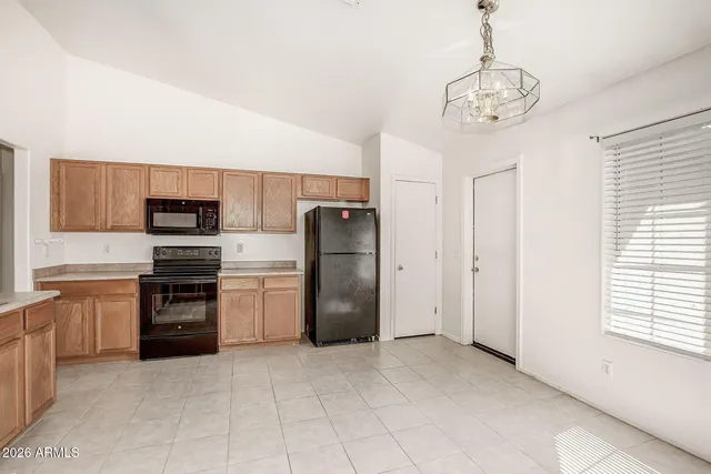a kitchen with stainless steel appliances granite countertop a refrigerator and a stove top oven