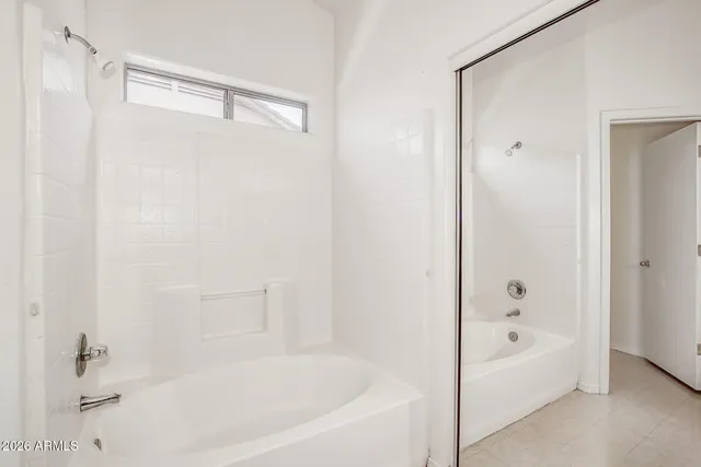 a white bath tub with a shower