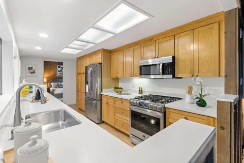 a bathroom with a double vanity sink toilet and a mirror