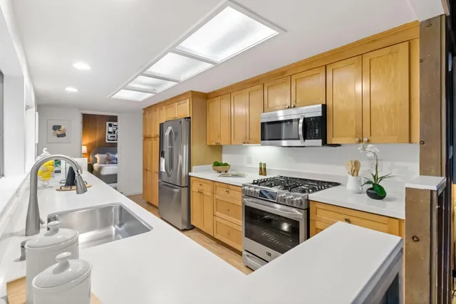 a bathroom with a double vanity sink toilet and a mirror