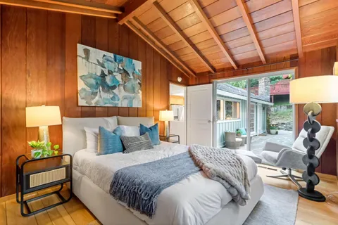 a bedroom with furniture and a window