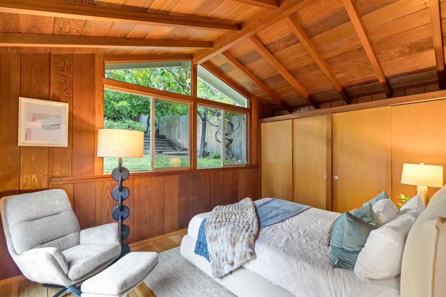 1019 Los Trancos Road Portola Valley, CA 94028 - Photo 29 of 63 a bedroom with furniture and a large window