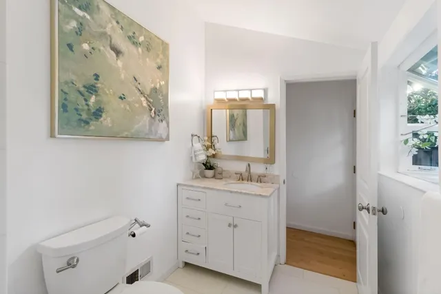 a living room with furniture and a lamp