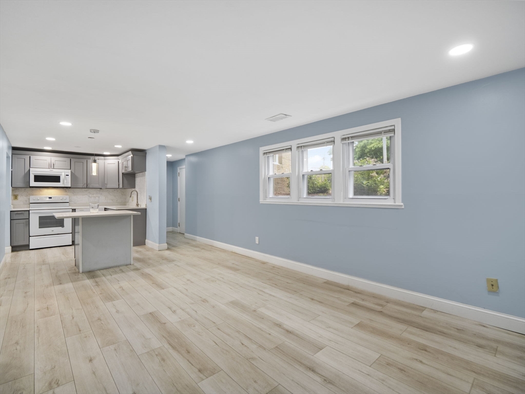 24 Bettys Pond Road, Unit K Barnstable, MA 02601 - Photo 13 of 40 a view of kitchen with wooden floor and window