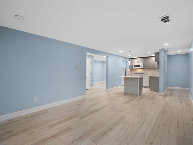 a view of a kitchen with a sink and a refrigerator