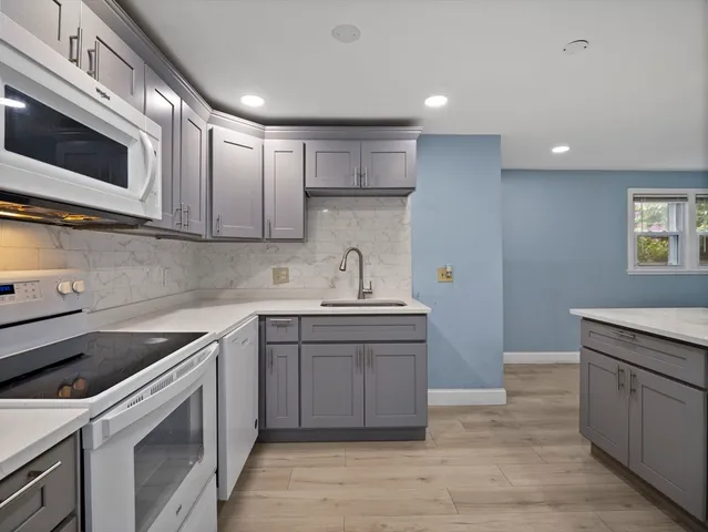 a kitchen with a sink cabinets and stainless steel appliances