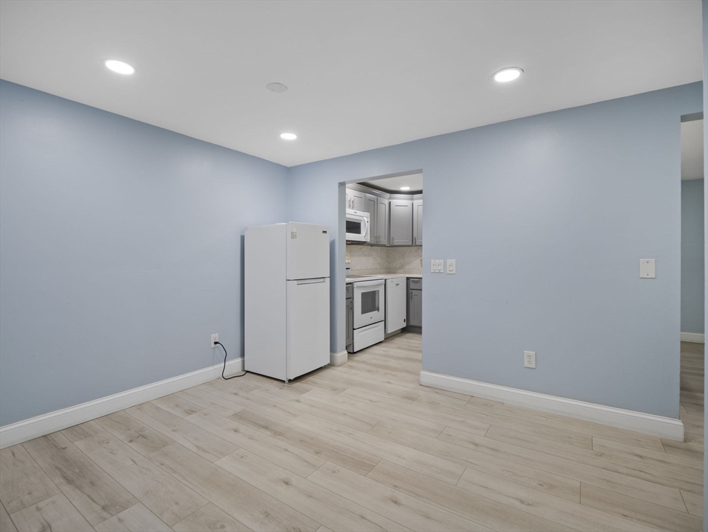 24 Bettys Pond Road, Unit K Barnstable, MA 02601 - Photo 23 of 40 a view of a kitchen with a sink and dishwasher a refrigerator with wooden floor